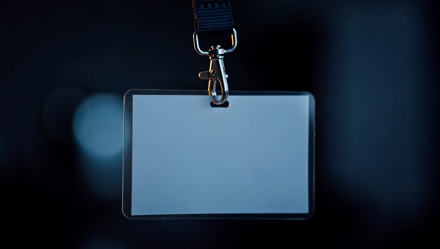 A blank event badge on a lanyard, waiting for a brand